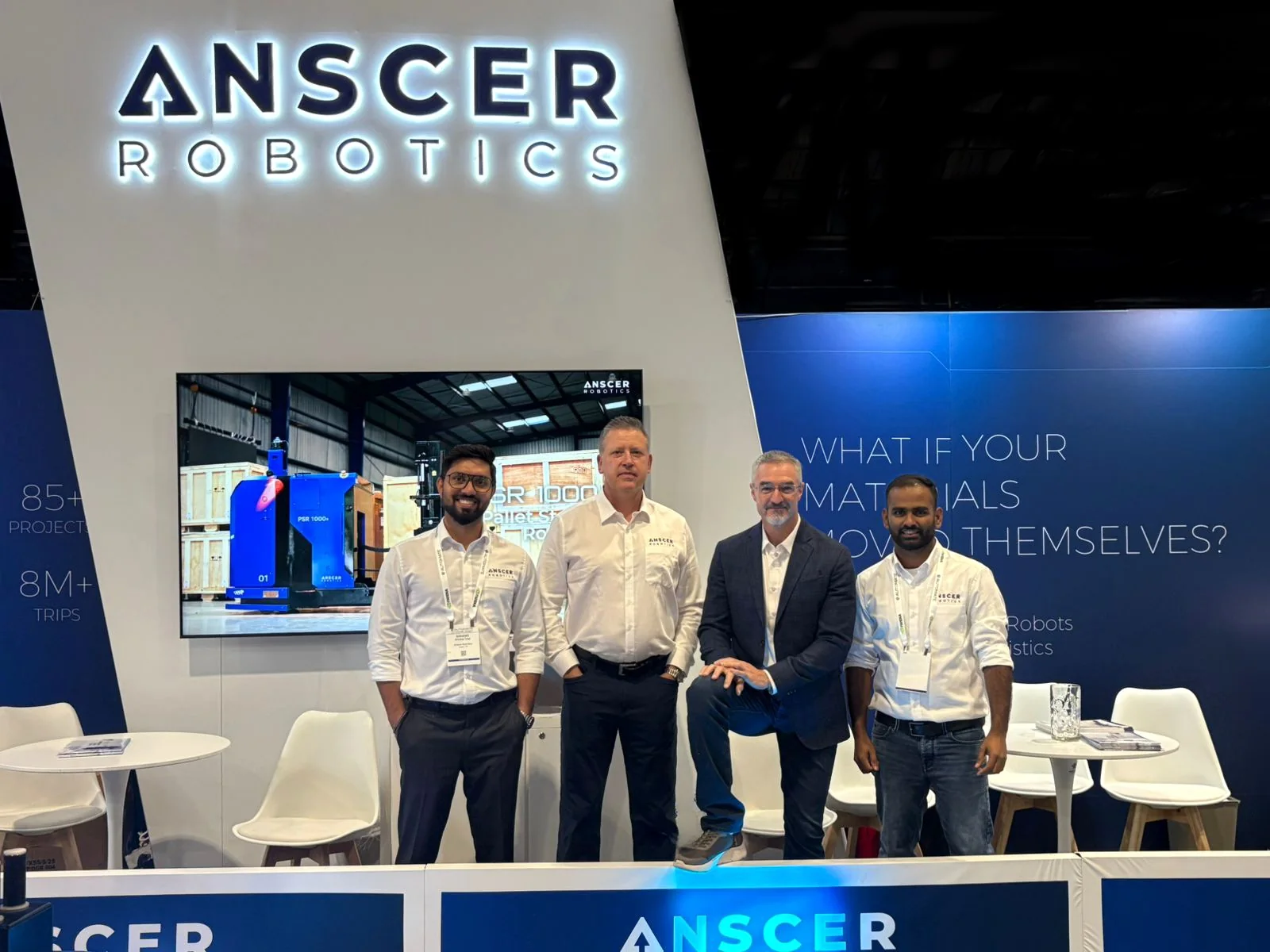 4 members of the ANSCER Robotics team standing in front of the company's trade show booth